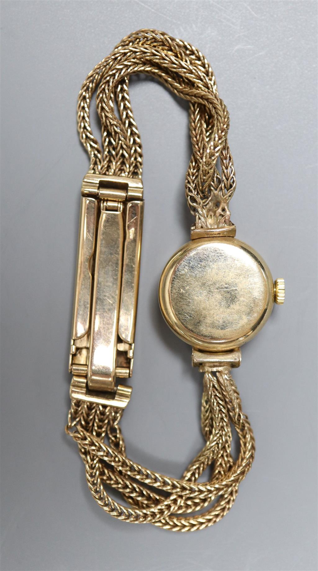 A ladys 1960s 9ct gold Omega manual wind wrist watch, on multi strand bracelet with expanding clasp,